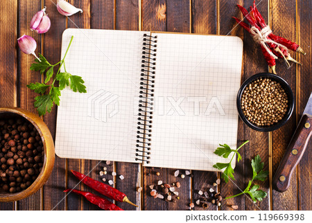 Open recipe book with fresh herbs and spices Open recipe book with fresh herbs and spices 119669398