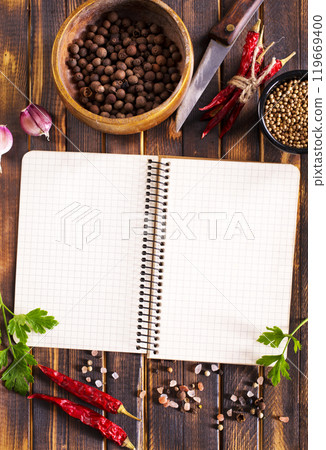 Open recipe book with fresh herbs and spices Open recipe book with fresh herbs and spices 119669400