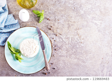 A fresh ricotta with basil leaf on stone table 119669483