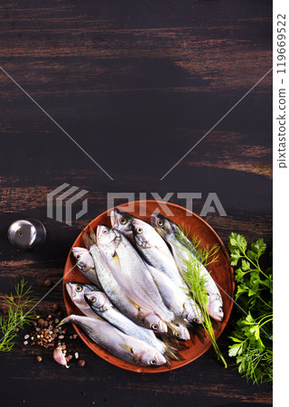 Small fish for cooking, fish on plate 119669522