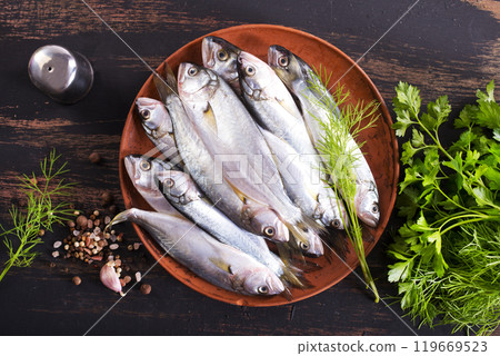 Small fish for cooking, fish on plate 119669523