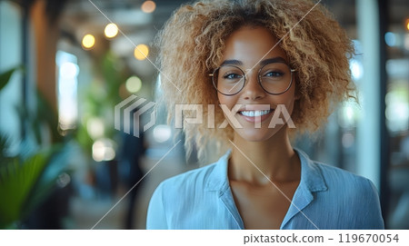 Confident female leaders walking through an open office, exchanging ideas and planning for the future, their positive energy and mutual respect clear in their conversation. 119670054