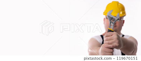 Construction Worker with Adjustable Wrench and Safety Helmet for site protection and effectiveness 119670151