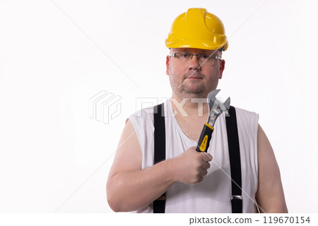 A Portrait of a Construction Worker Holding a Wrench and Wearing a Hard Hat for Safety A Portrait of a Construction Worker Holding a Wrench and Wearing a Hard Hat for Safety 119670154