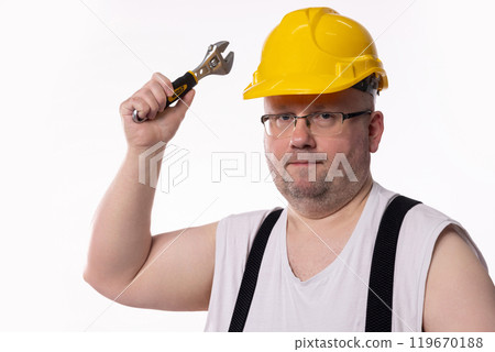 A Construction Worker Holding a Wrench, Wearing a Bright Yellow Hard Hat and Smiling A Construction Worker Holding a Wrench, Wearing a Bright Yellow Hard Hat and Smiling 119670188