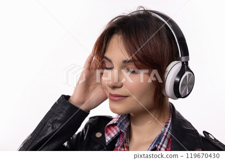 A Young Woman Wearing Stylish Headphones While Fully Enjoying and Immersing Herself in Music 119670430