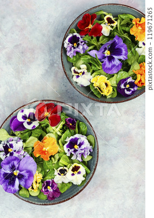 Bowls of mixed salad with edible flowers. 119671265