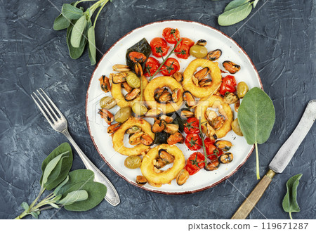 Grilled mussels with herbs and squid rings. Grilled mussels with herbs and squid rings. 119671287