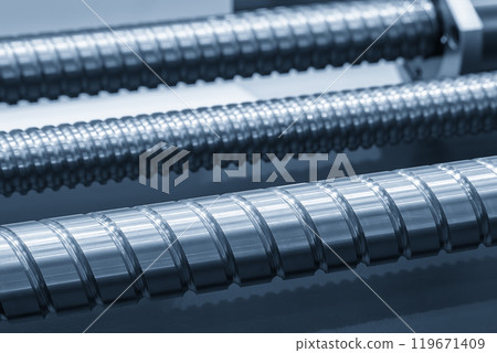 Closeup scene the spare parts lead ball screw parts in the light blue scene. Closeup scene the spare parts lead ball screw parts in the light blue scene. 119671409