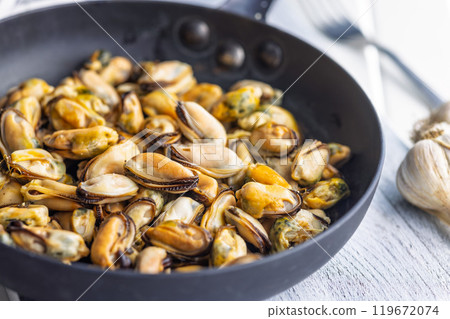 Shelled mussels meat in pan on white table Shelled mussels meat in pan on white table 119672074