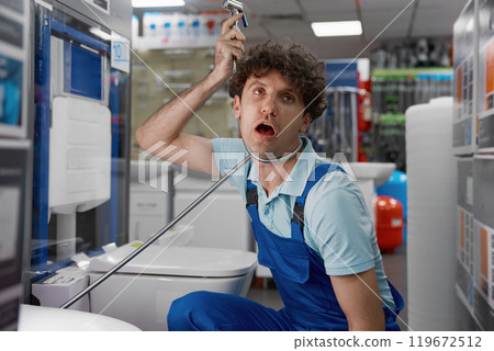 Comic plumber playing with water hose of luxury bidets toilet at plumbing store Comic plumber playing with water hose of luxury bidets toilet at plumbing store 119672512