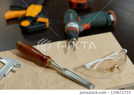 Carpentry tools and wooden board on workbench closeup selective focus Carpentry tools and wooden board on workbench closeup selective focus 119672735