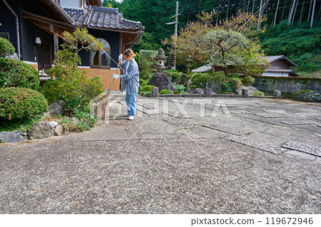 Woman sweeping the garden Countryside Old house Inn Life Woman sweeping the garden Countryside Old house Inn Life 119672946