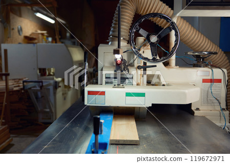 Woodworking thickness planer machine to trim wood plank closeup view, woodworking workshop Woodworking thickness planer machine to trim wood plank closeup view, woodworking workshop 119672971