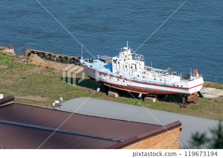 A boat on the river bank on a slipway. A boat on the river bank on a slipway. 119673194