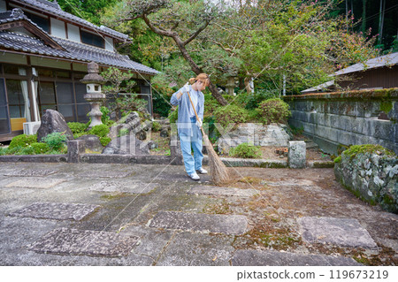 Woman sweeping the garden Countryside Old house Inn Life Woman sweeping the garden Countryside Old house Inn Life 119673219