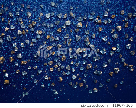 Scattered gemstones on a dark blue background Scattered gemstones on a dark blue background 119674166