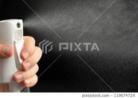 Spray water bottle in hand Spray water bottle in hand 119674729