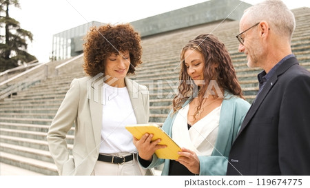 Businesspeople working on project using tablet near steps 119674775