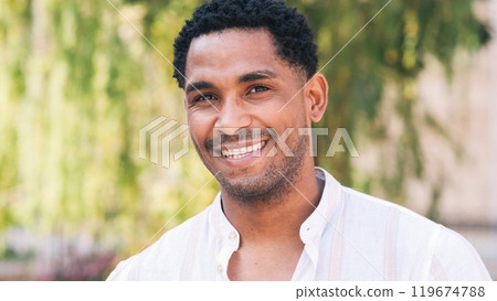 Closeup of happy man looking at camera on sunny day 119674788