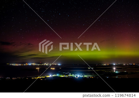 The Aurora Borealis, the northern lights, showing up above Maghery, Burtonport, Arranmore and Dungloe in County Donegal, Ireland. 119674814