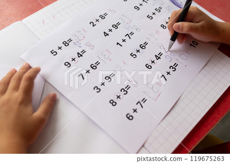 A childs math homework, affected by dyslexia and dyscalculia, is covered in corrections. A childs math homework, affected by dyslexia and dyscalculia, is covered in corrections. 119675263