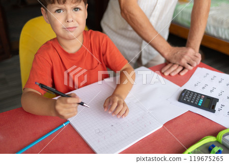 A child with dyscalculia and dyslexia struggles to complete homework. 119675265