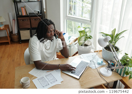 Focused Designer Working at Home Office Desk Focused Designer Working at Home Office Desk 119675442