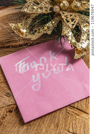 The word thank you is written with a white marker on a pink piece of paper 119676047