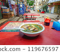 Ordering beef ramen on the terrace of a diner in a back alley in Zhuhai, China 119676597