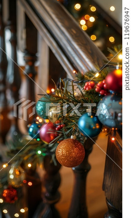 This detailed garland, featuring twinkling fairy lights and vibrant ornaments, is beautifully displayed on a wooden banister, enhancing the warm, festive atmosphere 119676947