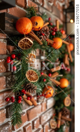 This Christmas garland, made of fresh greenery, holly, and shiny baubles, brings a festive and cozy atmosphere as it adorns a rustic brick wall 119677058