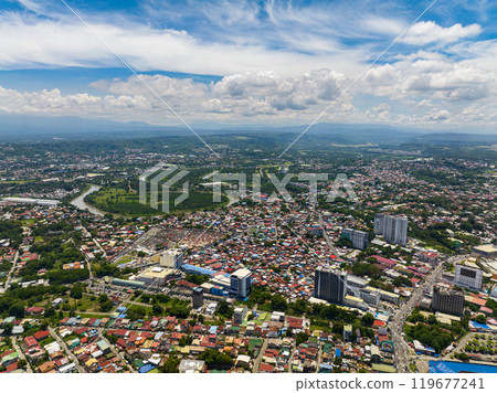 Beautiful blue sky and clouds above in Davao City. Eagle aerial view of River and cityscape of Davao City. Mindanao, Philippines. 119677241