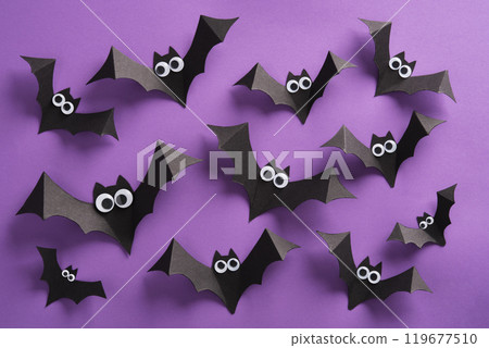 Cute paper bats with googly eyes on purple backdrop, Halloween backgrounds 119677510