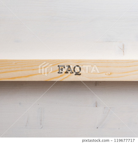 Wooden slat with a FAQ sign on it placed over plain simple wooden background Wooden slat with a FAQ sign on it placed over plain simple wooden background 119677717