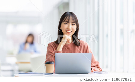 Smiling woman/businesswoman using a computer Smiling woman/businesswoman using a computer 119677981