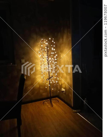 Christmas decorations of winter street in the center of Moscow, Russia. Glowing bright yellow trees made of diodes. Evening cityscape with bright night lights. A festive New Year shot. 119678007