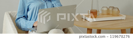 Working Remotely with a Laptop and Beverages Nearby 119678276