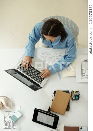 Working on Design Project From Above Working on Design Project From Above 119678323