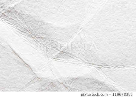 Close-up of crumpled white paper texture with wrinkles and folds for creative 119678395