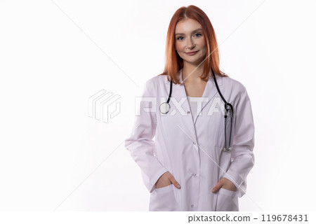 Confident and Skilled Female Doctor Wearing a Lab Coat and Holding a Stethoscope Confident and Skilled Female Doctor Wearing a Lab Coat and Holding a Stethoscope 119678431