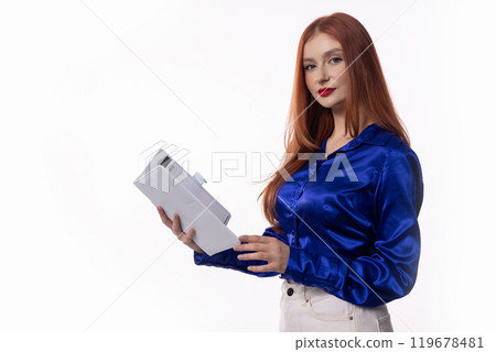 A Professional Woman Dressed in a Blue Satin Shirt Gracefully Holding a Document in Hand A Professional Woman Dressed in a Blue Satin Shirt Gracefully Holding a Document in Hand 119678481