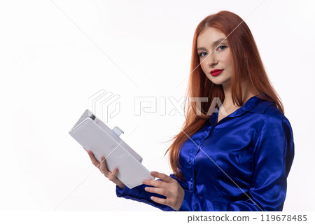 A Confident Businesswoman Dressed in Stylish and Professional Blue Attire, Holding a Tablet A Confident Businesswoman Dressed in Stylish and Professional Blue Attire, Holding a Tablet 119678485