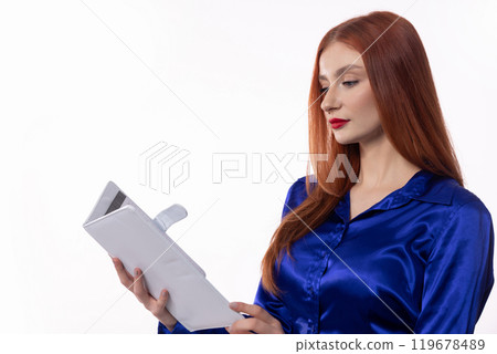 An Elegant Woman Deeply Engrossed in a Book While Dressed in Stylish and Fashionable Attire An Elegant Woman Deeply Engrossed in a Book While Dressed in Stylish and Fashionable Attire 119678489