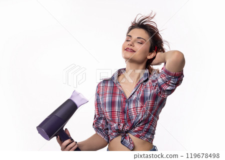 A Stylish Woman Confidently Using a Hair Dryer with Elegance and Grace in Her Routine 119678498