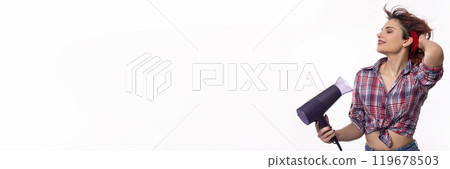 A Stylish and Young Woman Holding a Hair Dryer in a Fun and Playful Pose with Confidence A Stylish and Young Woman Holding a Hair Dryer in a Fun and Playful Pose with Confidence 119678503