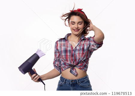 A Stylish Young Woman Dressed in a Trendy Outfit and Using a Hair Dryer for Her Hair A Stylish Young Woman Dressed in a Trendy Outfit and Using a Hair Dryer for Her Hair 119678513