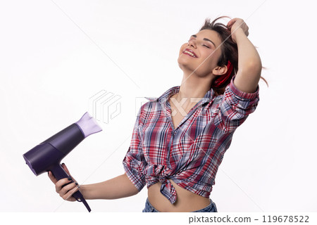 Stylish and Vibrant Young Woman Using a Hair Dryer in a Modern and Chic Setting Today 119678522