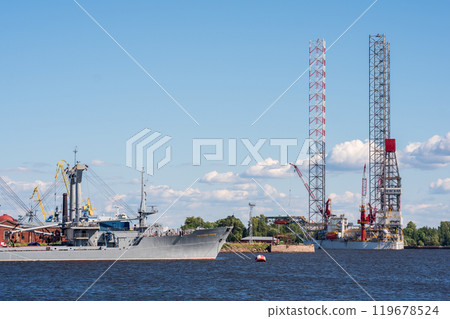 ships in a cargo port of Kronstadt, a jackup oil rig can be seen in the background ships in a cargo port of Kronstadt, a jackup oil rig can be seen in the background 119678524
