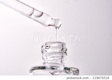 Close-up of a cosmetic bottle with a pipette showing the texture of the serum. 119678526